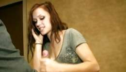 What a suggestive babe giving nice handjob to her bf and talks on a phone at a same time